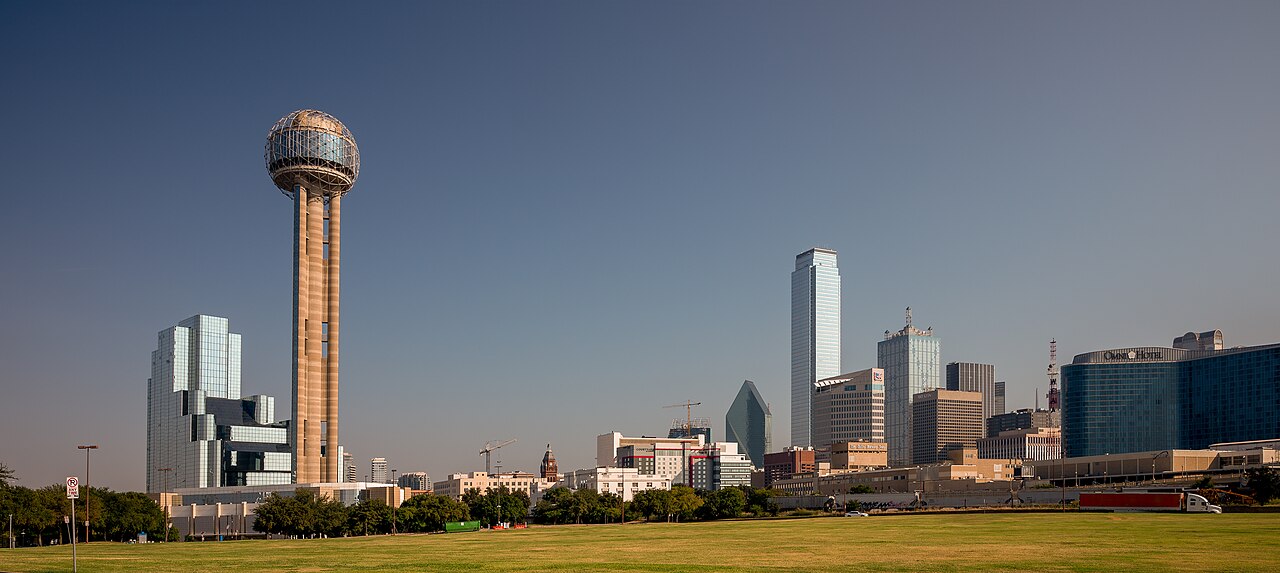 Actual Reunion Tower and downtown Dallas skyline across a green lawn