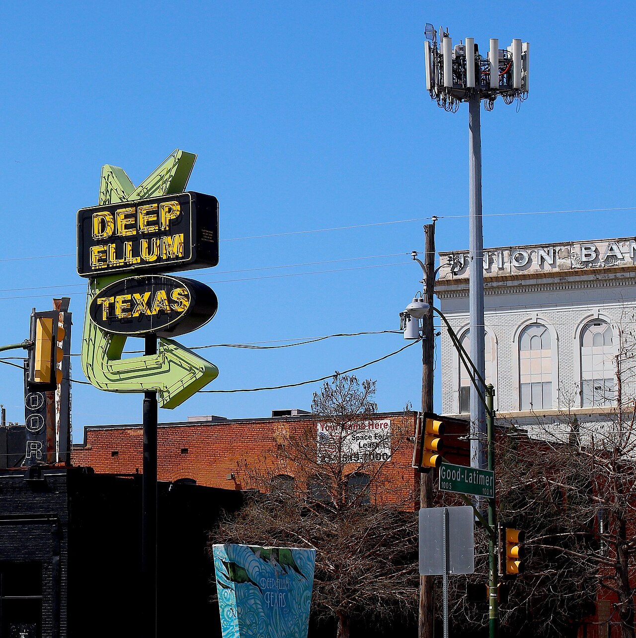 Deep Ellum street sign against a blue Dallas sky